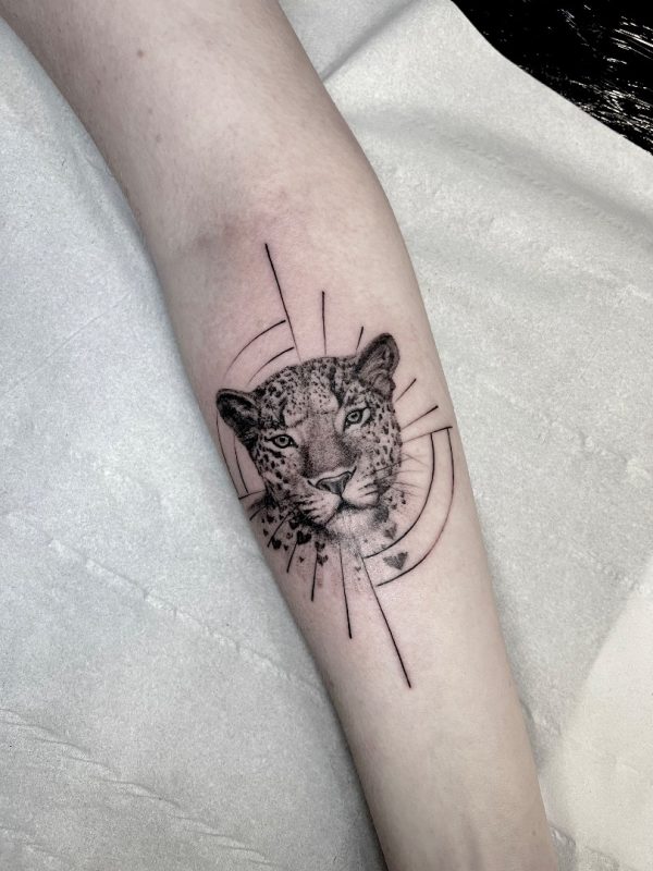 Minimalist geometric wild cat tattoo in fine line black ink